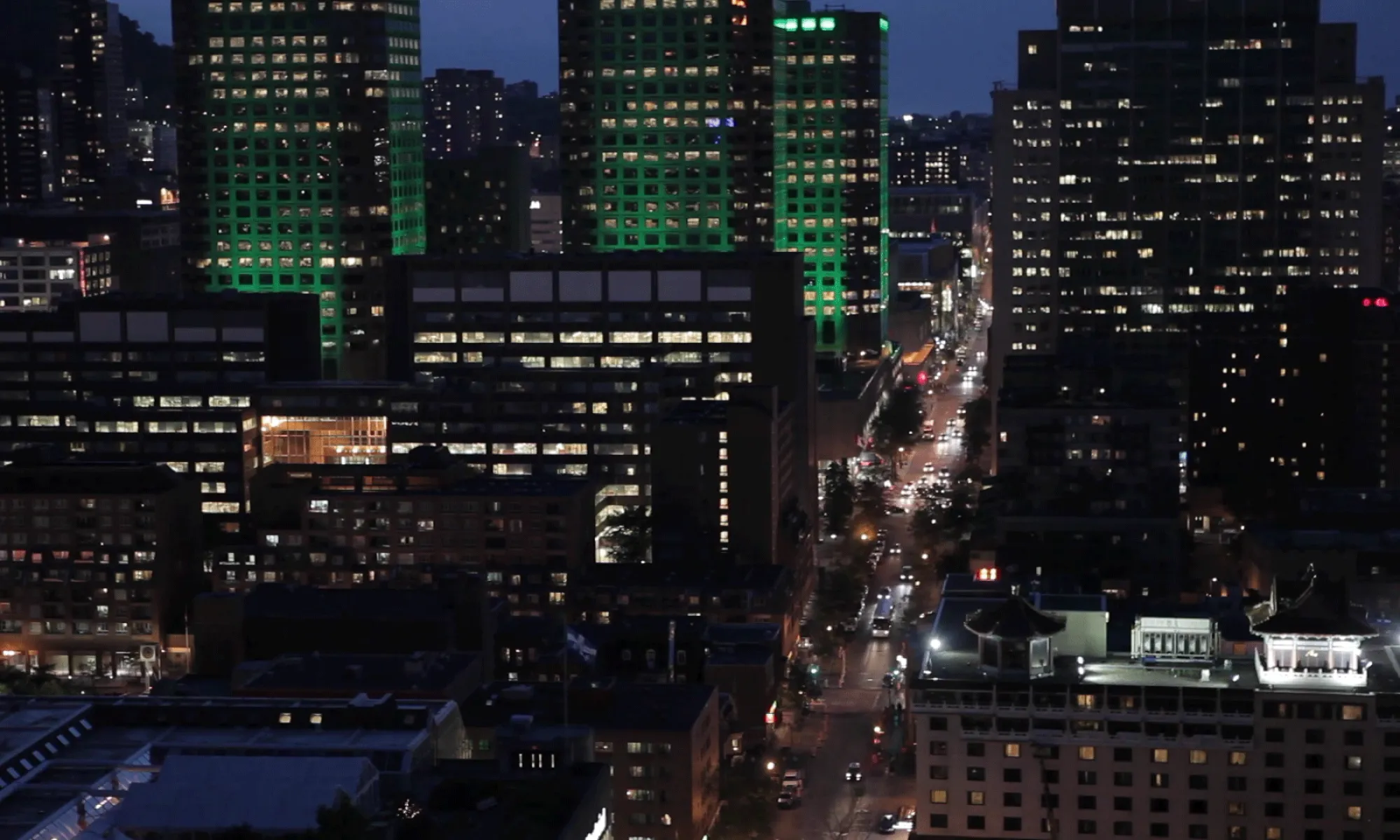 A city at dusk with lit office buildings